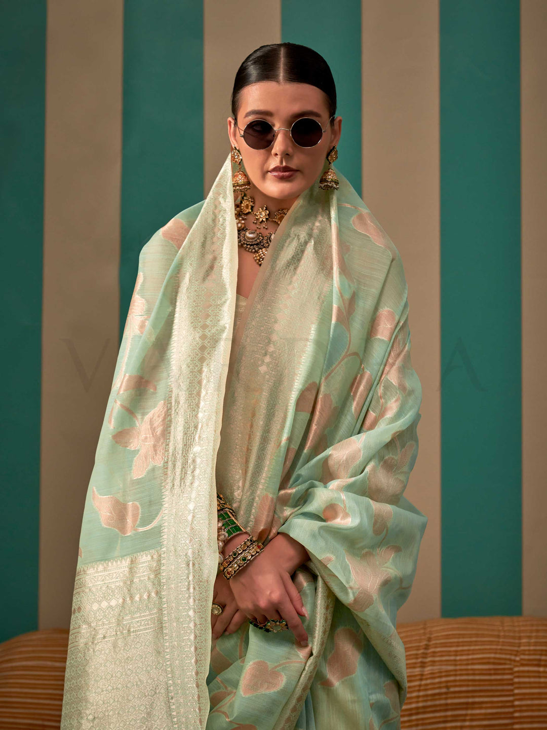 Aqua Green and Cream linen saree with floral woven motifs and soft handloom texture This image captures the model styling perspective with complete saree ensemble displayed, ideal for visualizing festive elegance, designer appeal, and modern styling inspiration. Perfect for online shoppers seeking detailed previews before purchase, enhancing saree visual merchandising and SEO-rich product display strategy.                                                                                                       