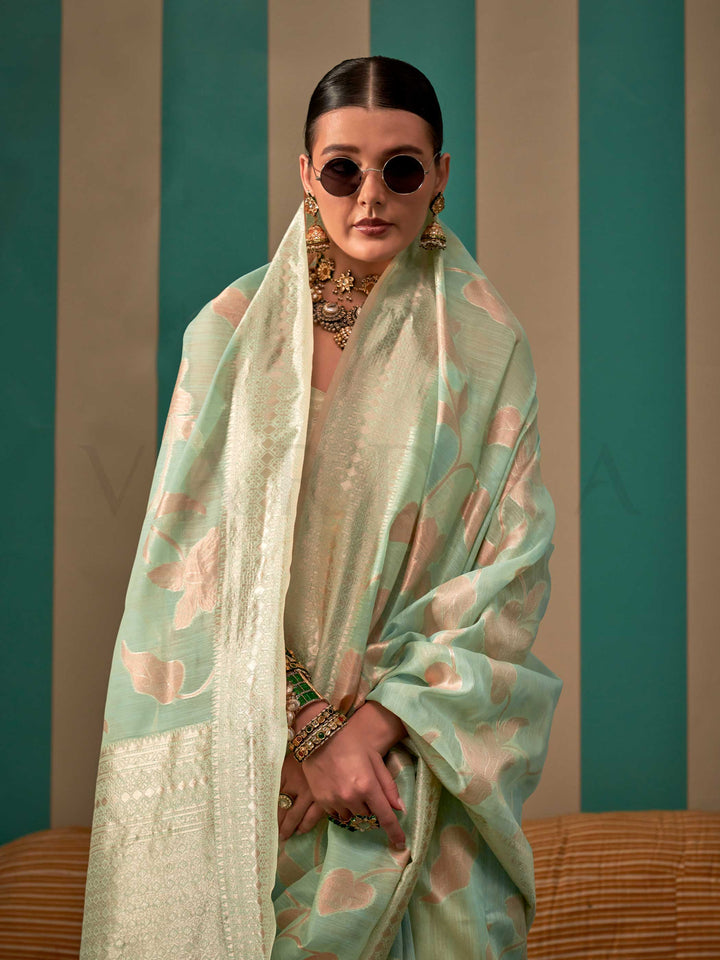 Aqua Green and Cream linen saree with floral woven motifs and soft handloom texture This image captures the model styling perspective with complete saree ensemble displayed, ideal for visualizing festive elegance, designer appeal, and modern styling inspiration. Perfect for online shoppers seeking detailed previews before purchase, enhancing saree visual merchandising and SEO-rich product display strategy.                                                                                                       