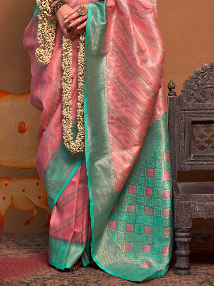 Pink and Sea Green striped silk saree with handloom weave and checked pallu. Ideal for wedding functions like reception look, styled with heritage jewelry and temple-inspired accessories. This image captures the back drape focus revealing pallu finesse and motif richness, ideal for visualizing festive elegance, designer appeal, and modern styling inspiration. Perfect for online shoppers seeking detailed previews before purchase, enhancing saree visual merchandising and SEO-rich product display strategy.    