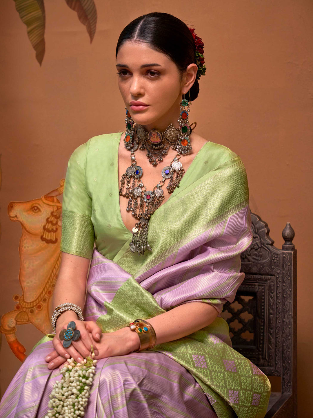 Lavender and Pista Green striped silk saree with handloom weave and checked pallu. Ideal for sangeet functions like sister of bride, styled with heritage jewelry and temple-inspired accessories. This image captures the pleats close-up showing symmetry, color blending, and craftsmanship, ideal for visualizing festive elegance, designer appeal, and modern styling inspiration. Perfect for online shoppers seeking detailed previews before purchase, enhancing saree visual merchandising and SEO-rich product displa
