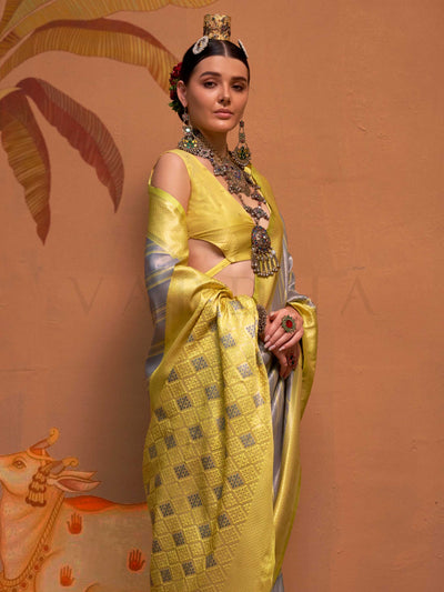 Lemon Yellow and Grey striped silk saree with handloom weave and checked pallu. Ideal for bollywood functions like editorial fashion, styled with heritage jewelry and temple-inspired accessories. This image captures the model styling perspective with complete saree ensemble displayed, ideal for visualizing festive elegance, designer appeal, and modern styling inspiration. Perfect for online shoppers seeking detailed previews before purchase, enhancing saree visual merchandising and SEO-rich product display 