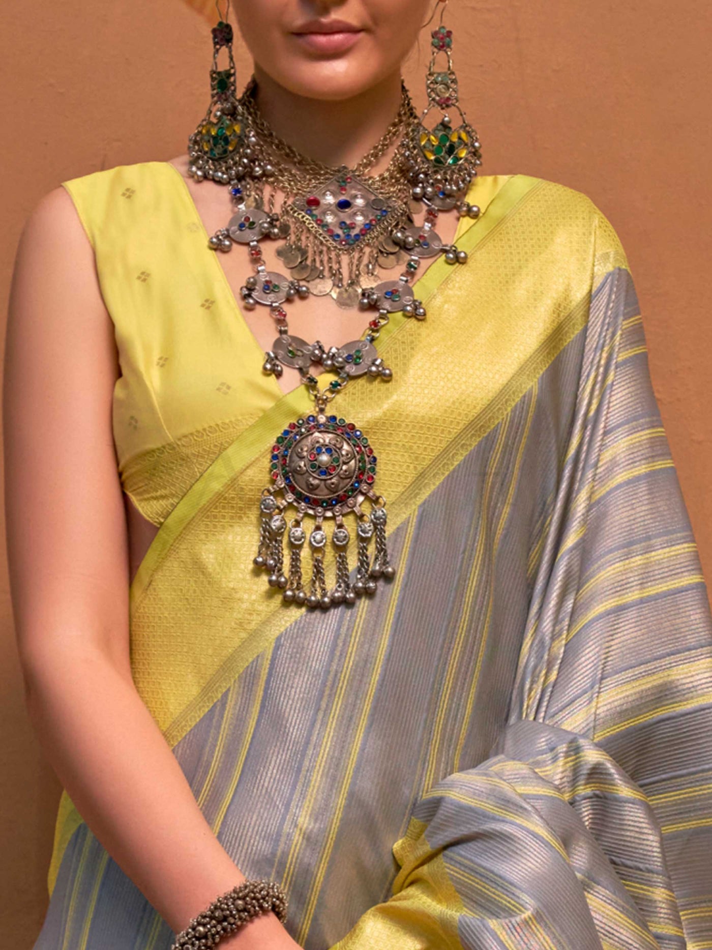 Lemon Yellow and Grey striped silk saree with handloom weave and checked pallu. Ideal for bollywood functions like editorial fashion, styled with heritage jewelry and temple-inspired accessories. This image captures the zoomed texture view illustrating fabric weave and print clarity, ideal for visualizing festive elegance, designer appeal, and modern styling inspiration. Perfect for online shoppers seeking detailed previews before purchase, enhancing saree visual merchandising and SEO-rich product display s