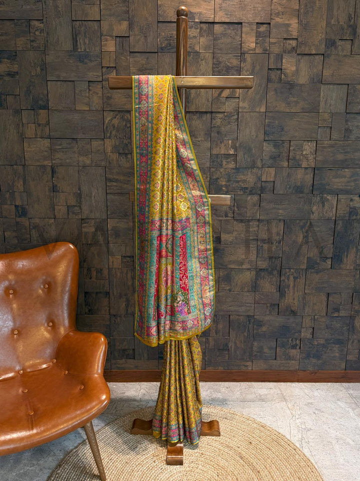 Colorful patterned fabric draped over a wooden stand against a textured wall.