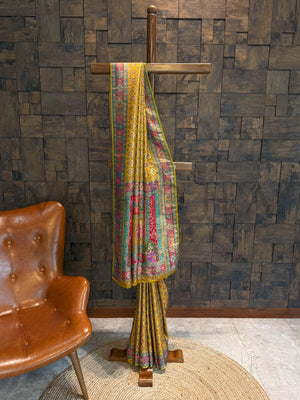 Colorful patterned fabric draped over a wooden stand against a textured wall.