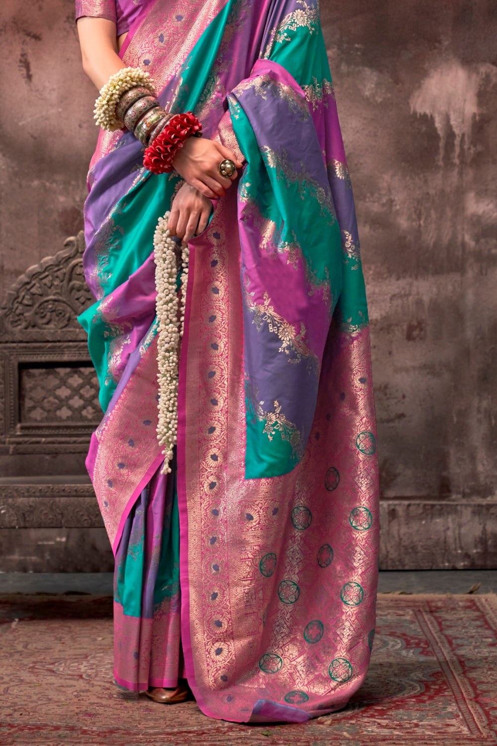 Purple and Aqua Blue Rangkaat silk saree with temple borders, intricate zari pallu, and traditional wedding styling. Handloom drape perfect for wedding functions and south indian muhurtham, styled with mogra, antique jewelry, and regal stance. This image captures the side angle view showcasing blouse styling and zari border detail, ideal for visualizing festive elegance, designer appeal, and modern styling inspiration. Perfect for online shoppers seeking detailed previews before purchase, enhancing saree vi