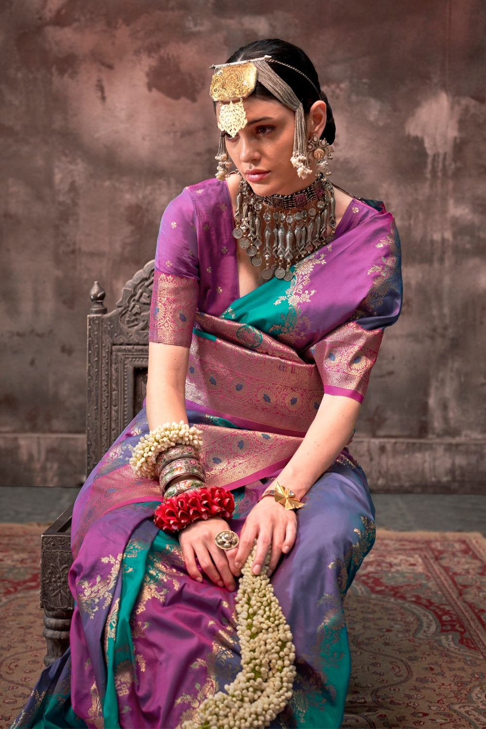 Purple and Aqua Blue Rangkaat silk saree with temple borders, intricate zari pallu, and traditional wedding styling. Handloom drape perfect for wedding functions and south indian muhurtham, styled with mogra, antique jewelry, and regal stance. This image captures the model styling perspective with complete saree ensemble displayed, ideal for visualizing festive elegance, designer appeal, and modern styling inspiration. Perfect for online shoppers seeking detailed previews before purchase, enhancing saree vi