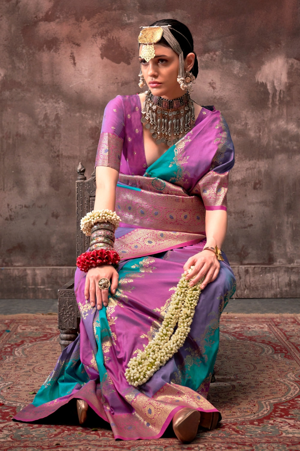Purple and Aqua Blue Rangkaat silk saree with temple borders, intricate zari pallu, and traditional wedding styling. Handloom drape perfect for wedding functions and south indian muhurtham, styled with mogra, antique jewelry, and regal stance. This image captures the pleats close-up showing symmetry, color blending, and craftsmanship, ideal for visualizing festive elegance, designer appeal, and modern styling inspiration. Perfect for online shoppers seeking detailed previews before purchase, enhancing saree