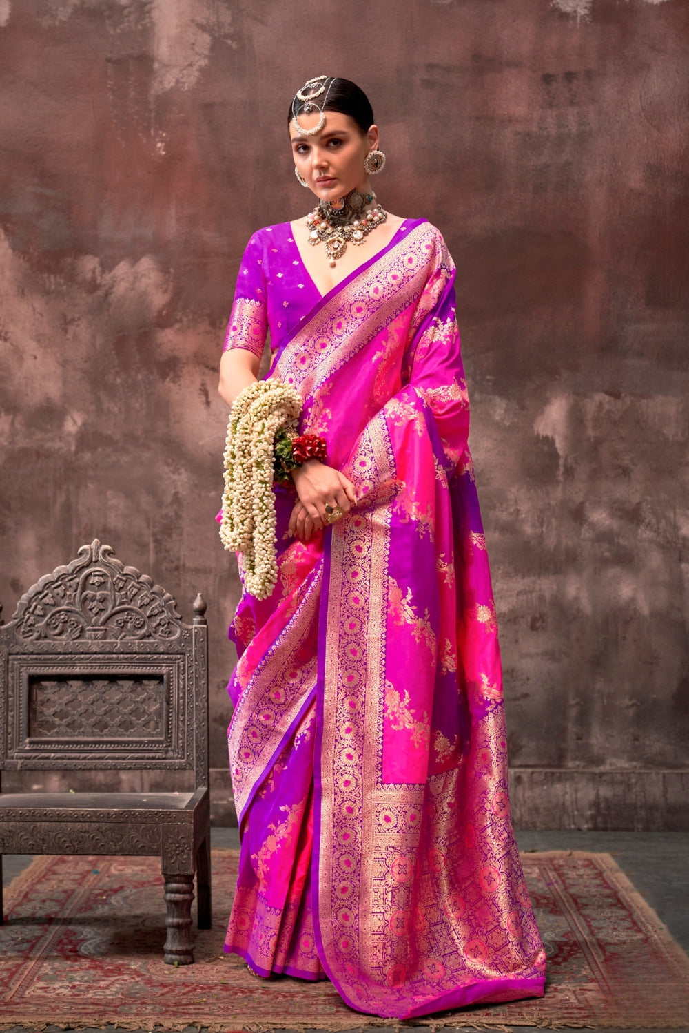 Rani Pink and Magenta Rangkaat silk saree with temple borders, intricate zari pallu, and traditional wedding styling. Handloom drape perfect for sangeet functions and bridal sangeet, styled with mogra, antique jewelry, and regal stance. This image captures the model styling perspective with complete saree ensemble displayed, ideal for visualizing festive elegance, designer appeal, and modern styling inspiration. Perfect for online shoppers seeking detailed previews before purchase, enhancing saree visual me
