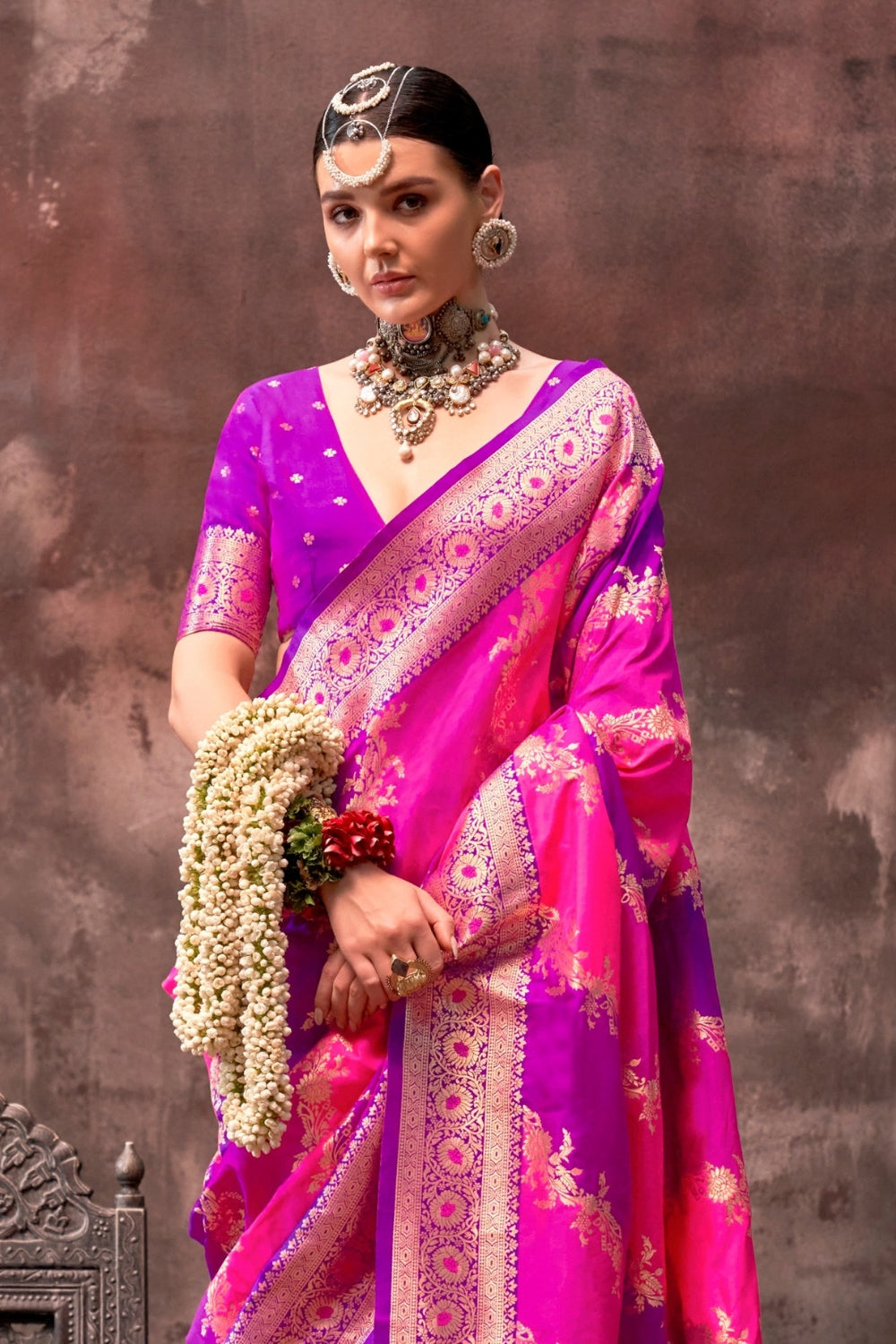 Rani Pink and Magenta Rangkaat silk saree with temple borders, intricate zari pallu, and traditional wedding styling. Handloom drape perfect for sangeet functions and bridal sangeet, styled with mogra, antique jewelry, and regal stance. This image captures the side angle view showcasing blouse styling and zari border detail, ideal for visualizing festive elegance, designer appeal, and modern styling inspiration. Perfect for online shoppers seeking detailed previews before purchase, enhancing saree visual me