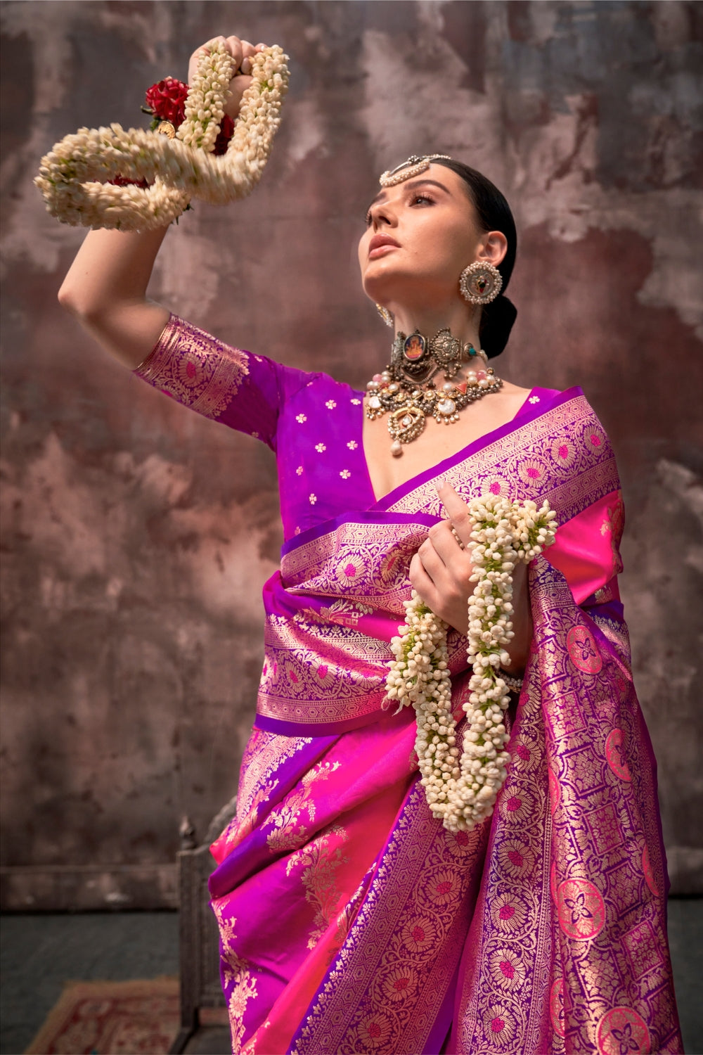 Rani Pink and Magenta Rangkaat silk saree with temple borders, intricate zari pallu, and traditional wedding styling. Handloom drape perfect for sangeet functions and bridal sangeet, styled with mogra, antique jewelry, and regal stance. This image captures the zoomed texture view illustrating fabric weave and print clarity, ideal for visualizing festive elegance, designer appeal, and modern styling inspiration. Perfect for online shoppers seeking detailed previews before purchase, enhancing saree visual mer