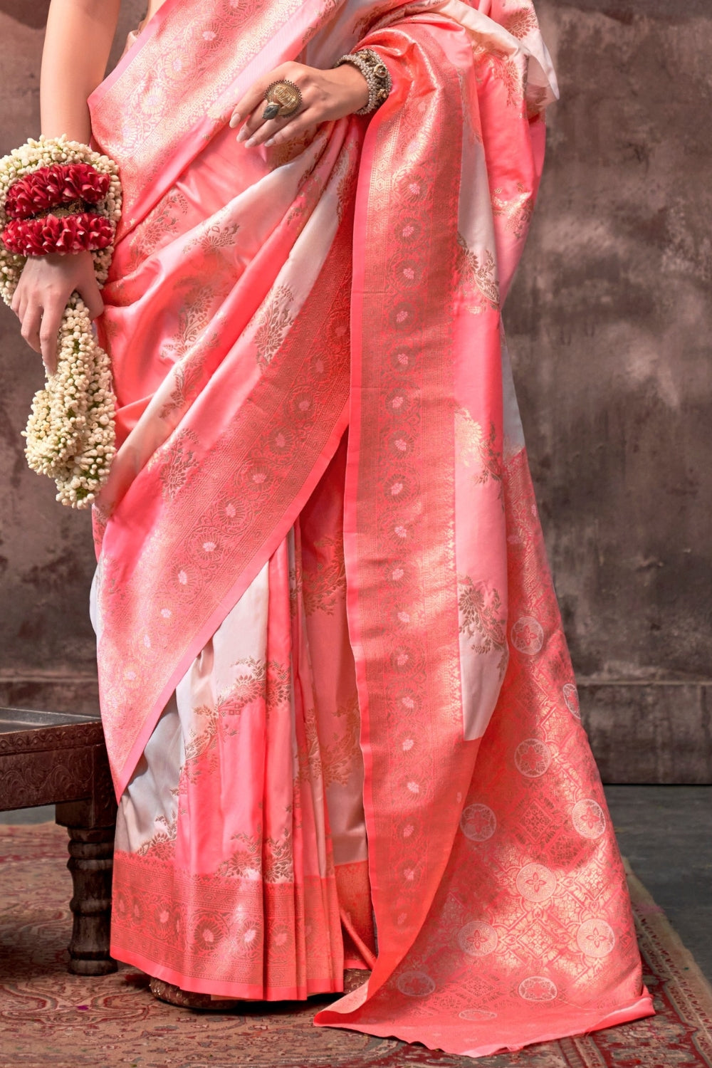 Blush Coral and Silver Rangkaat silk saree with temple borders, intricate zari pallu, and traditional wedding styling. Handloom drape perfect for festive season functions and karwachauth, diwali, styled with mogra, antique jewelry, and regal stance. This image captures the side angle view showcasing blouse styling and zari border detail, ideal for visualizing festive elegance, designer appeal, and modern styling inspiration. Perfect for online shoppers seeking detailed previews before purchase, enhancing sa