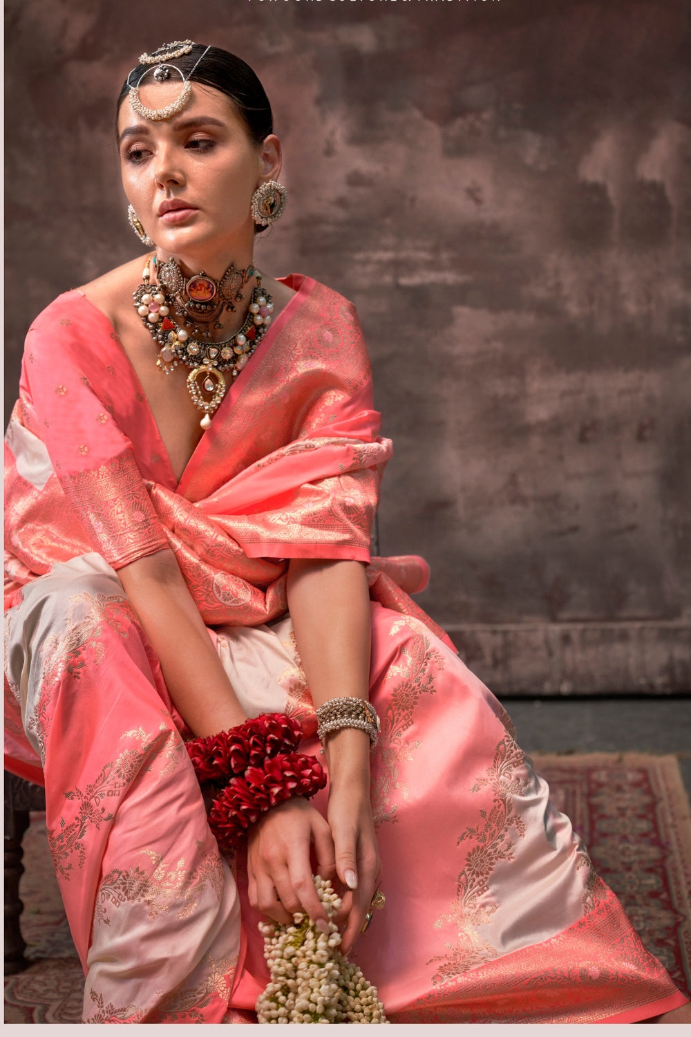 Blush Coral and Silver Rangkaat silk saree with temple borders, intricate zari pallu, and traditional wedding styling. Handloom drape perfect for festive season functions and karwachauth, diwali, styled with mogra, antique jewelry, and regal stance. This image captures the model styling perspective with complete saree ensemble displayed, ideal for visualizing festive elegance, designer appeal, and modern styling inspiration. Perfect for online shoppers seeking detailed previews before purchase, enhancing sa