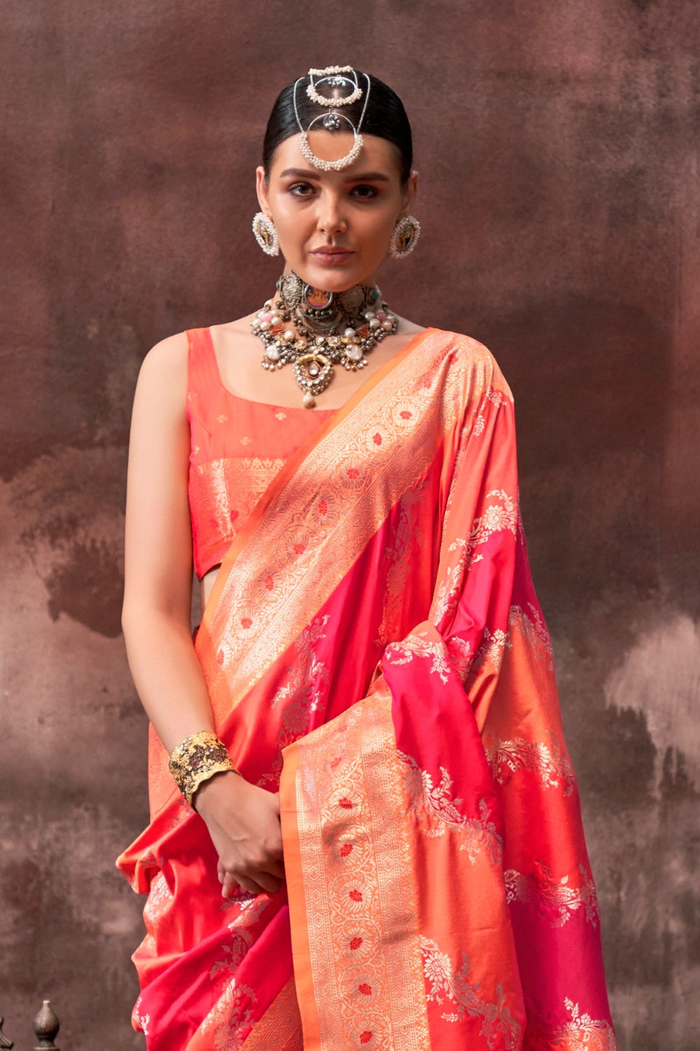Vermilion Orange and Gold Rangkaat silk saree with temple borders, intricate zari pallu, and traditional wedding styling. Handloom drape perfect for wedding functions and engagement or muhurtham, styled with mogra, antique jewelry, and regal stance. This image captures the back drape focus revealing pallu finesse and motif richness, ideal for visualizing festive elegance, designer appeal, and modern styling inspiration. Perfect for online shoppers seeking detailed previews before purchase, enhancing saree v