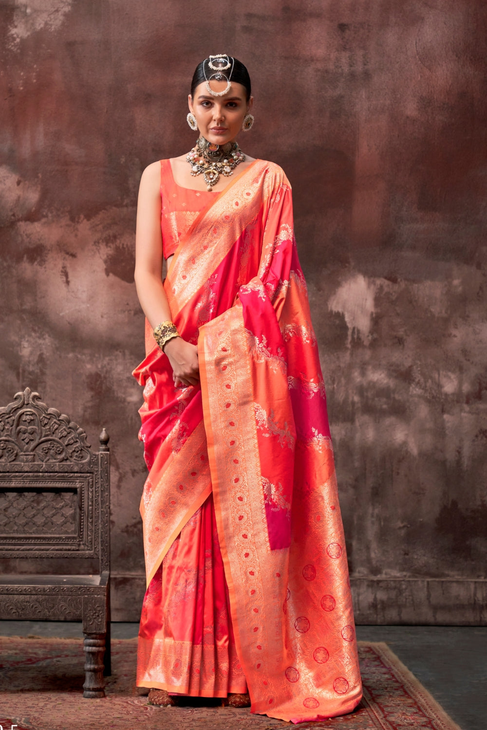 Vermilion Orange and Gold Rangkaat silk saree with temple borders, intricate zari pallu, and traditional wedding styling. Handloom drape perfect for wedding functions and engagement or muhurtham, styled with mogra, antique jewelry, and regal stance. This image captures the front drape view highlighting pallu fall and pleats alignment, ideal for visualizing festive elegance, designer appeal, and modern styling inspiration. Perfect for online shoppers seeking detailed previews before purchase, enhancing saree