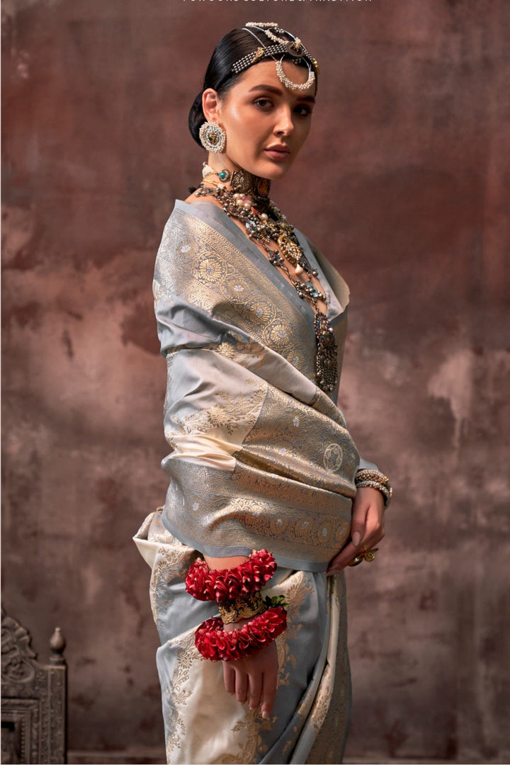 Pearl Grey and Ivory Rangkaat silk saree with temple borders, intricate zari pallu, and traditional wedding styling. Handloom drape perfect for party-wear functions and reception or gala, styled with mogra, antique jewelry, and regal stance. This image captures the zoomed texture view illustrating fabric weave and print clarity, ideal for visualizing festive elegance, designer appeal, and modern styling inspiration. Perfect for online shoppers seeking detailed previews before purchase, enhancing saree visua