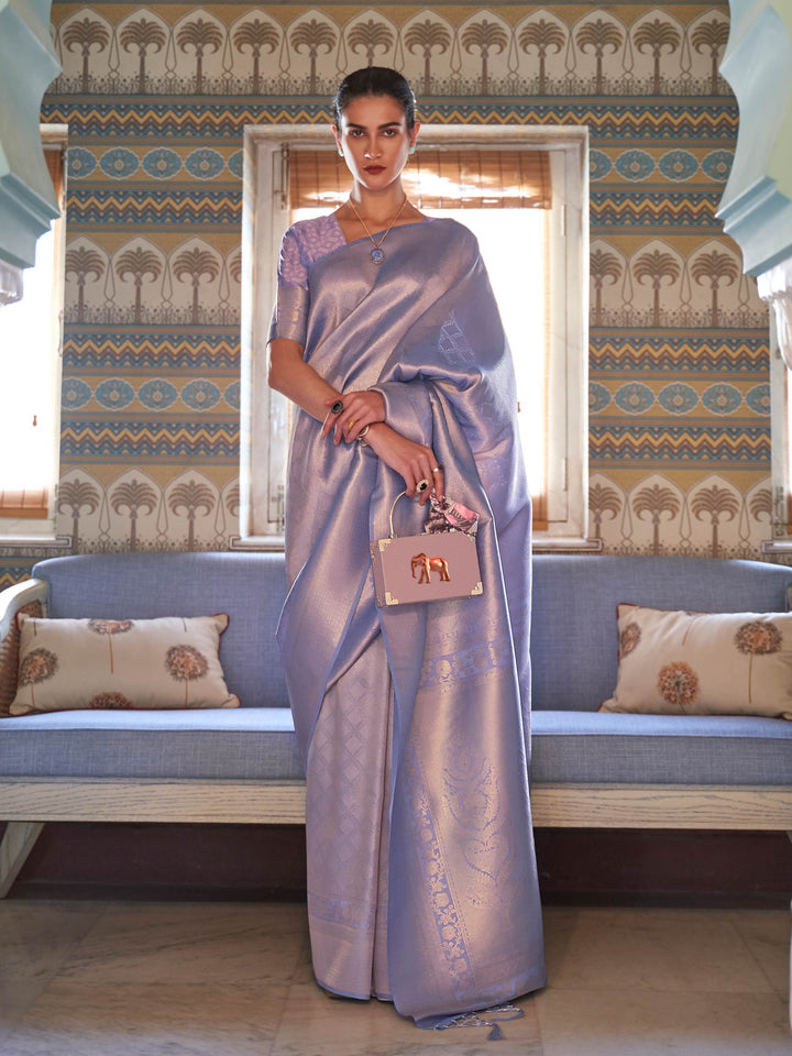 Lilac–Silver silk saree with woven zari motifs and kanjivaram texture, ideal for weddings. Elegant Lilac–Silver kanjivaram silk saree featuring gold/silver threadwork and festive pallu.