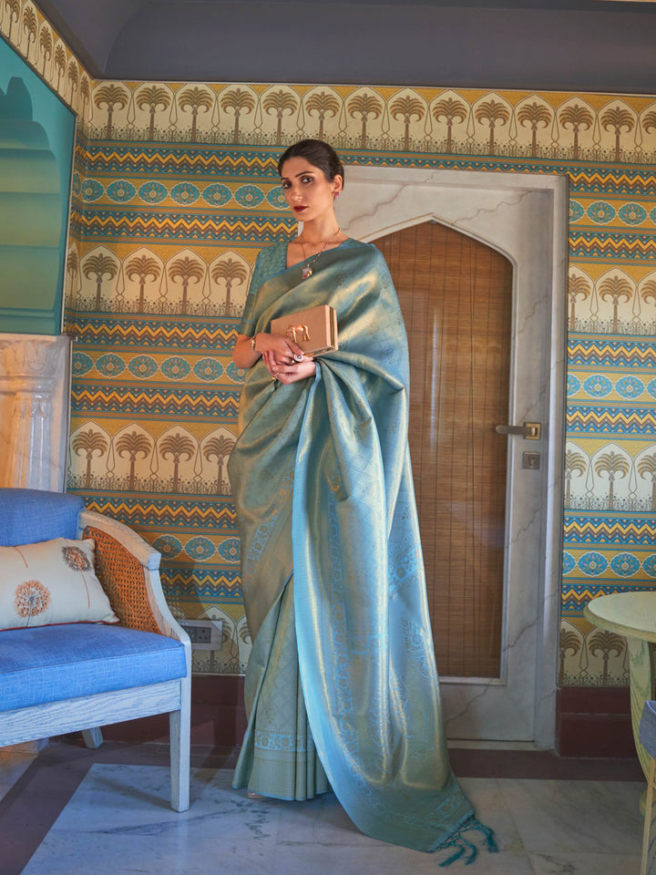 Aqua Blue–Gold silk saree with woven zari motifs and kanjivaram texture, ideal for weddings. Elegant Aqua Blue–Gold kanjivaram silk saree featuring gold/silver threadwork and festive pallu.