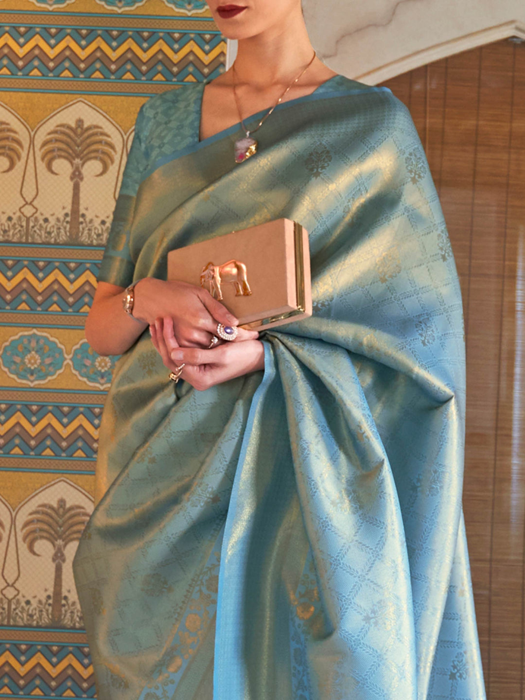 Stylish Aqua Blue–Gold kanjivaram with woven borders and jacquard design for ethnic events. Traditional Aqua Blue–Gold silk saree styled with soft zari pallu and unstitched blouse.