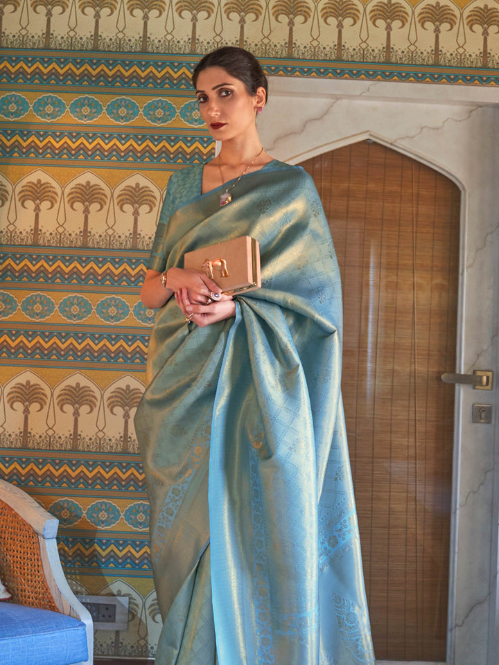 Soft Aqua Blue–Gold drape with traditional zari border, jacquard weave and blouse piece. Classic Indian festive silk saree in Aqua Blue–Gold with woven motifs for poojas and haldi.