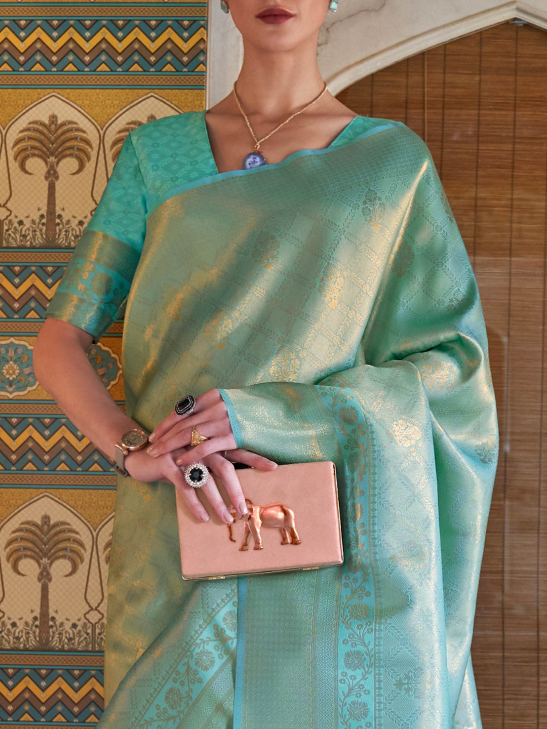 Stylish Mint Green–Gold kanjivaram with woven borders and jacquard design for ethnic events. Traditional Mint Green–Gold silk saree styled with soft zari pallu and unstitched blouse.