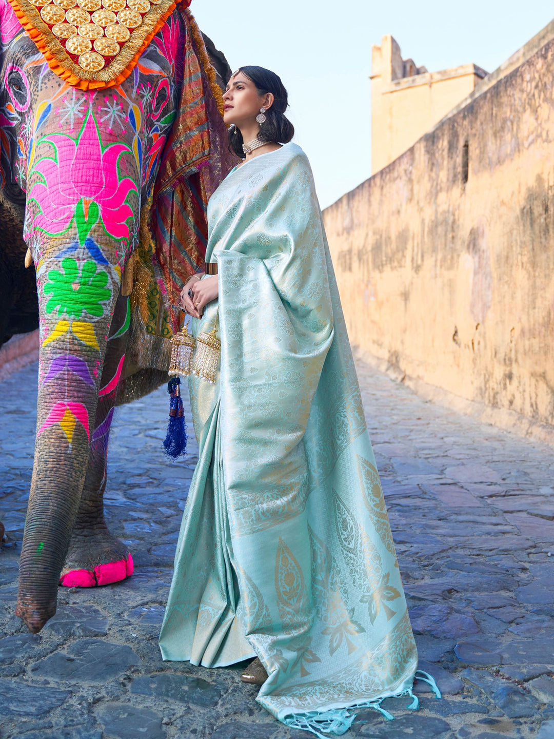 Mint Blue–Gold kanjivaram silk saree featuring gold zari motifs and elegant drape for festive occasions. Classic Mint Blue–Gold silk saree with woven zari borders and festive pallu.