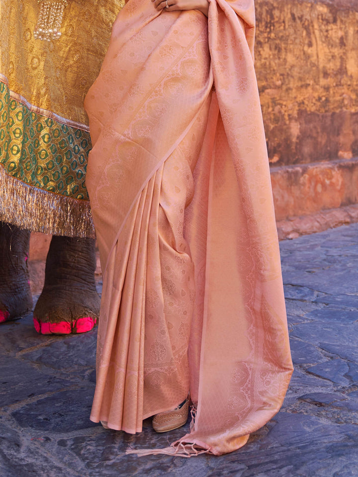 Traditional silk weave with gold accents across Peach–Gold body and pallu. Elegant Peach–Gold saree in kanjivaram silk for poojas and family celebrations.