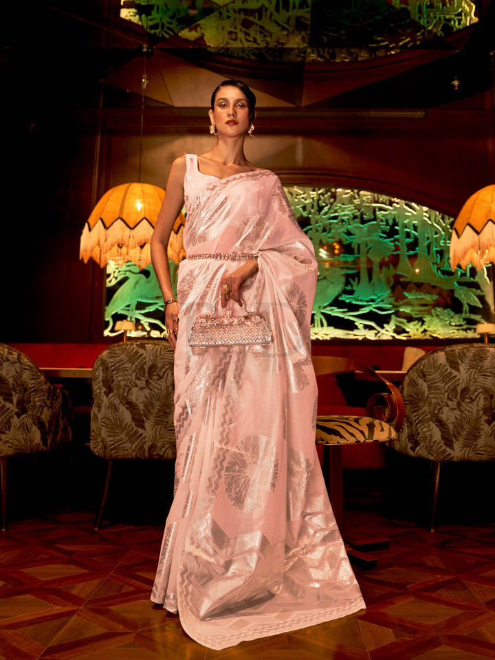 This Blush Pink–Silver Organza saree features subtle silver woven detailing for a dreamy, feather-light silhouette ideal for receptions, photoshoots, and elegant gatherings. Designed for lightness, movement, and soft glamour. SKU 255001. This Blush Pink–Silver Organza saree features subtle silver woven detailing for a dreamy, feather-light silhouette ideal for receptions, photoshoots, and elegant gatherings. Designed for lightness, movement, and soft glamour. SKU 255001.