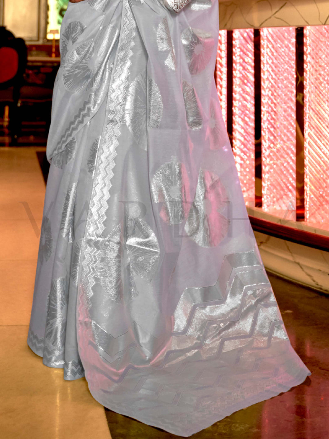 This Frost Blue–Silver Organza saree features subtle silver woven detailing for a dreamy, feather-light silhouette ideal for receptions, photoshoots, and elegant gatherings. Designed for lightness, movement, and soft glamour. SKU 255002. This Frost Blue–Silver Organza saree features subtle silver woven detailing for a dreamy, feather-light silhouette ideal for receptions, photoshoots, and elegant gatherings. Designed for lightness, movement, and soft glamour. SKU 255002.