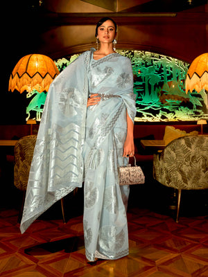 This Sky Blue–Silver Organza saree features subtle silver woven detailing for a dreamy, feather-light silhouette ideal for receptions, photoshoots, and elegant gatherings. Designed for lightness, movement, and soft glamour. SKU 255004. This Sky Blue–Silver Organza saree features subtle silver woven detailing for a dreamy, feather-light silhouette ideal for receptions, photoshoots, and elegant gatherings. Designed for lightness, movement, and soft glamour. SKU 255004.