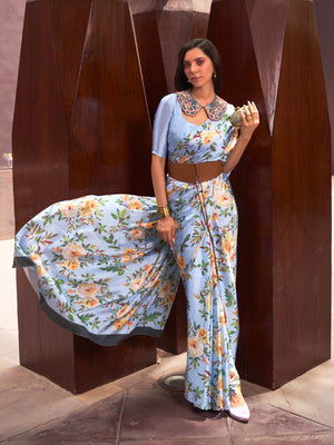 This Sky Blue–Peach Satin Crepe saree showcases stunning digital floral print that enhances its party-ready drape. Digitally crafted floral elegance for day-to-night ethnic wear. SKU 260004. This Sky Blue–Peach Satin Crepe saree showcases stunning digital floral print that enhances its party-ready drape. Digitally crafted floral elegance for day-to-night ethnic wear. SKU 260004.