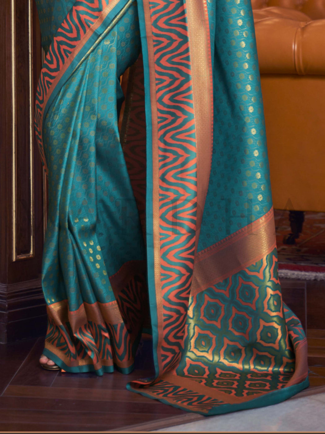 This luxurious Teal Blue–Copper Kanjivaram Silk saree features classic woven zari work with contrast pallu and ornate detailing. Elegant wedding attire with heritage style and timeless drape. SKU 271001. This luxurious Teal Blue–Copper Kanjivaram Silk saree features classic woven zari work with contrast pallu and ornate detailing. Elegant wedding attire with heritage style and timeless drape. SKU 271001.