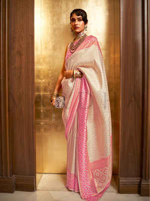 This luxurious Ivory–Baby Pink Kanjivaram Silk saree features classic woven zari work with contrast pallu and ornate detailing. Elegant wedding attire with heritage style and timeless drape. SKU 271003. This luxurious Ivory–Baby Pink Kanjivaram Silk saree features classic woven zari work with contrast pallu and ornate detailing. Elegant wedding attire with heritage style and timeless drape. SKU 271003.