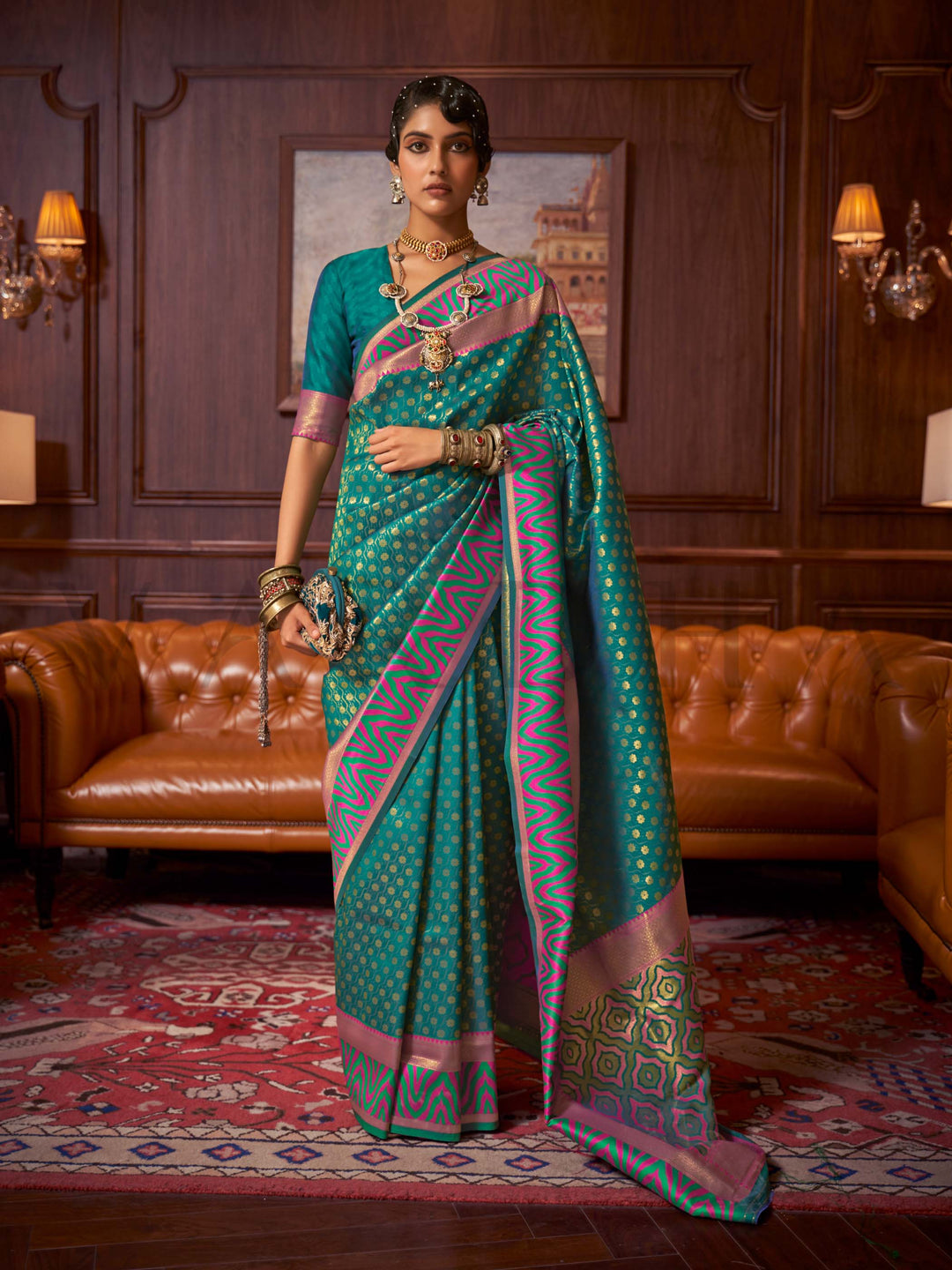 This luxurious Emerald Teal–Pink Kanjivaram Silk saree features classic woven zari work with contrast pallu and ornate detailing. Elegant wedding attire with heritage style and timeless drape. SKU 271006. This luxurious Emerald Teal–Pink Kanjivaram Silk saree features classic woven zari work with contrast pallu and ornate detailing. Elegant wedding attire with heritage style and timeless drape. SKU 271006.
