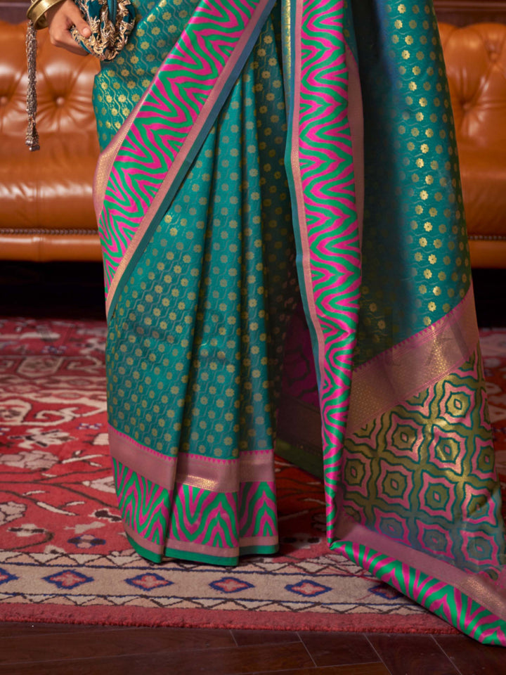 This luxurious Emerald Teal–Pink Kanjivaram Silk saree features classic woven zari work with contrast pallu and ornate detailing. Elegant wedding attire with heritage style and timeless drape. SKU 271006. This luxurious Emerald Teal–Pink Kanjivaram Silk saree features classic woven zari work with contrast pallu and ornate detailing. Elegant wedding attire with heritage style and timeless drape. SKU 271006.