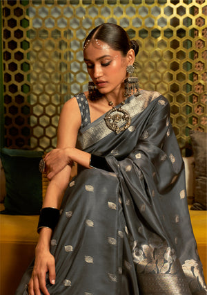 This Graphite Grey–Silver Satin Silk saree features exquisite zari weave, designed for weddings, festive events, and cultural celebrations. Ideal for graceful draping and traditional styling. SKU 287006. This Graphite Grey–Silver Satin Silk saree features exquisite zari weave, designed for weddings, festive events, and cultural celebrations. Ideal for graceful draping and traditional styling. SKU 287006.