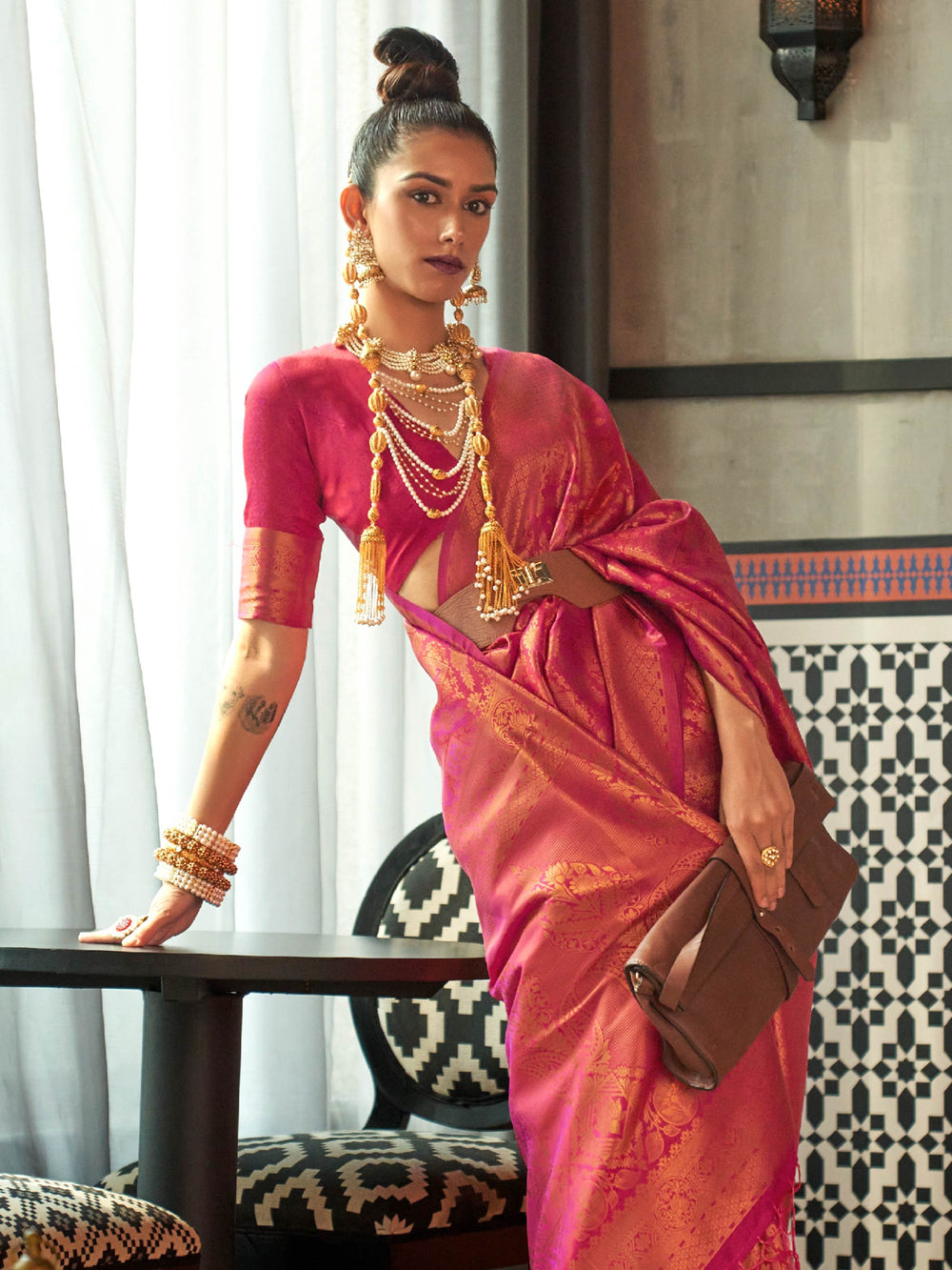 Elegant kanjivaram saree in magenta-pink hues with woven pallu and traditional bridal vibe. Bridal kanjivaram silk saree with zari border and rose-magenta silk drape for ceremonial occasions.