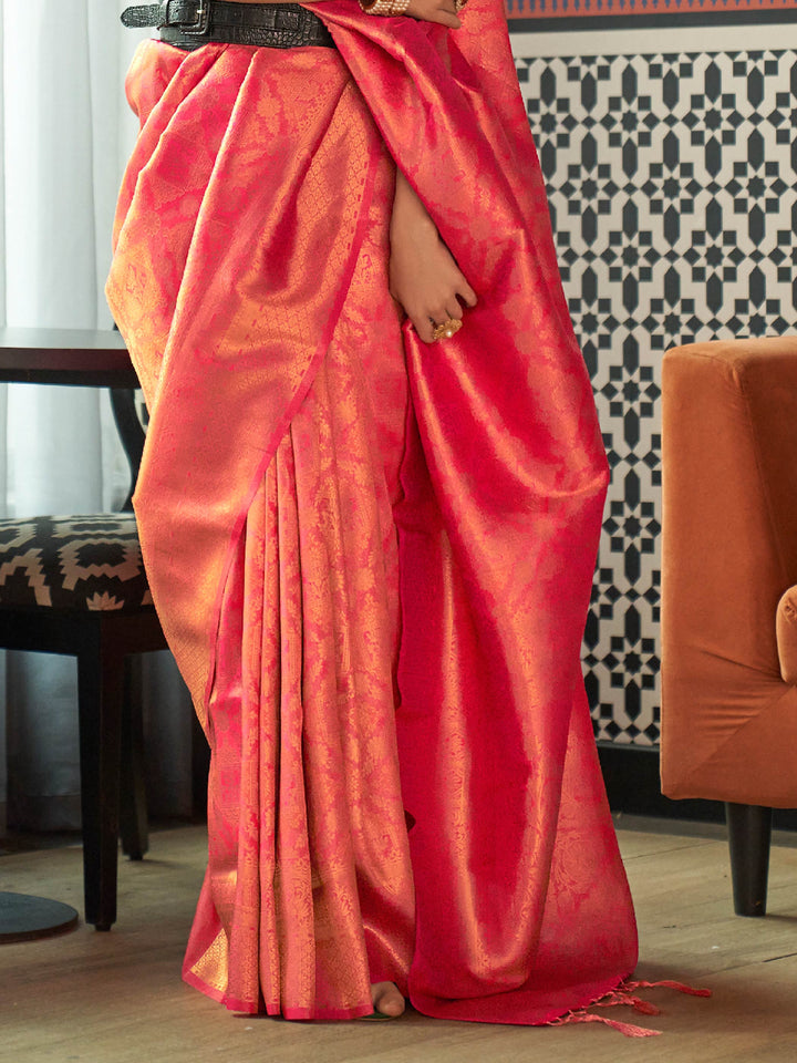 Glossy kanjivaram weave in Coral Red–Sunset Orange with intricate pallu motifs and elegant fall. Classic Coral Red–Sunset Orange bridal saree in silk with woven zari pallu and tassel finish.