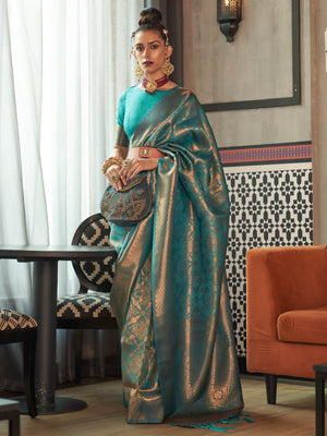 Teal Blue–Antique Gold kanjivaram silk saree with traditional zari motifs and bridal styling for grand events. Two-tone wedding saree in Teal Blue–Antique Gold with jacquard pallu and festive bridal drape.