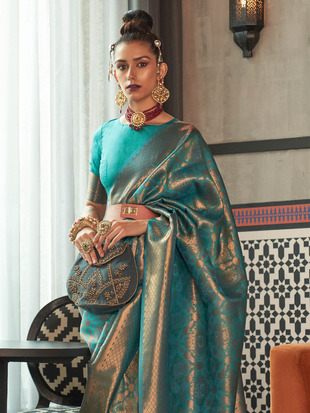 Teal Blue–Antique Gold silk saree featuring temple borders, zari detailing and dual-tone richness. Wedding-ready kanjivaram saree in Teal Blue–Antique Gold styled with regal accessories and clutch.