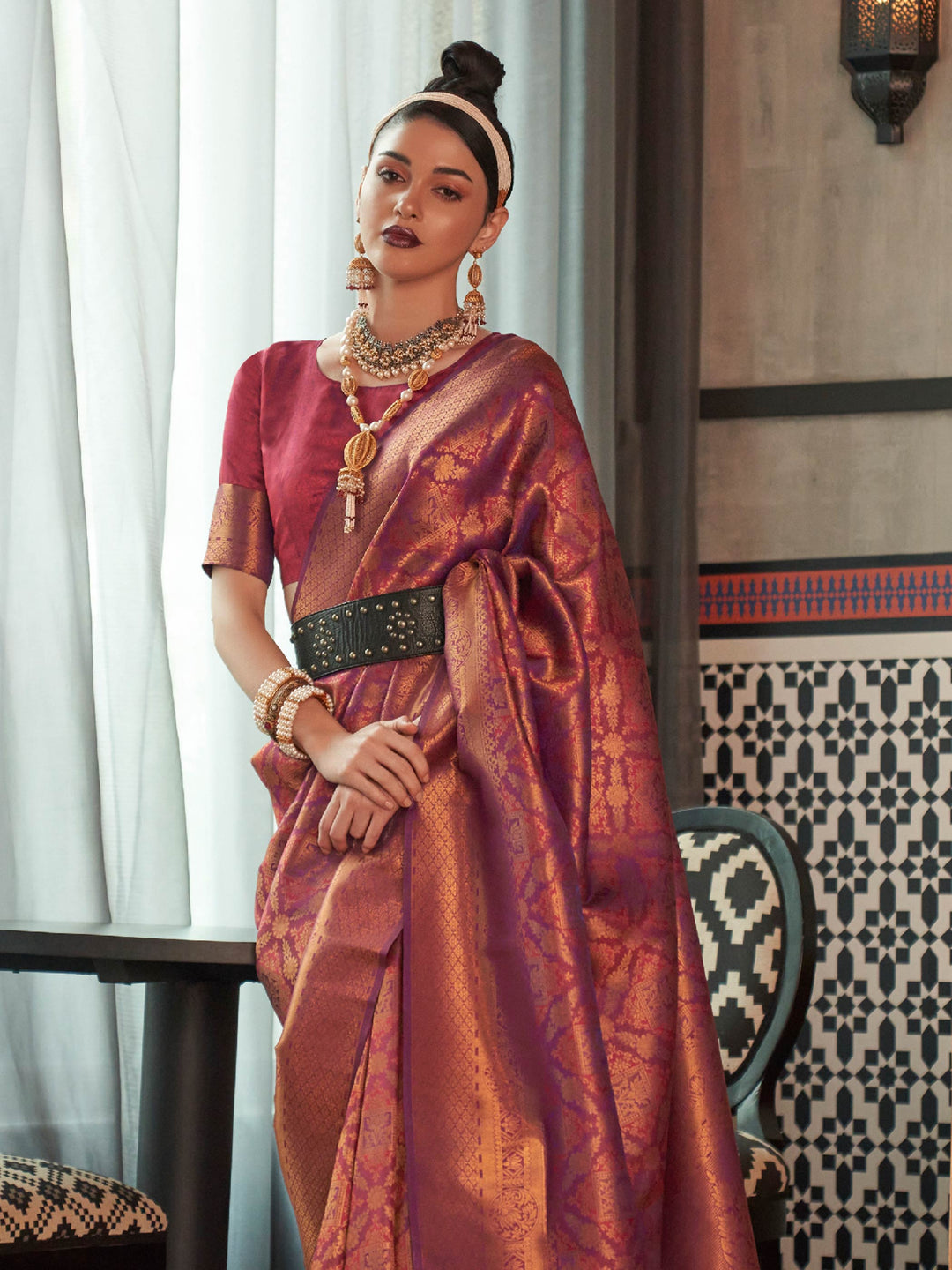 Maroon–Copper silk saree featuring temple borders, zari detailing and dual-tone richness. Wedding-ready kanjivaram saree in Maroon–Copper styled with regal accessories and clutch.