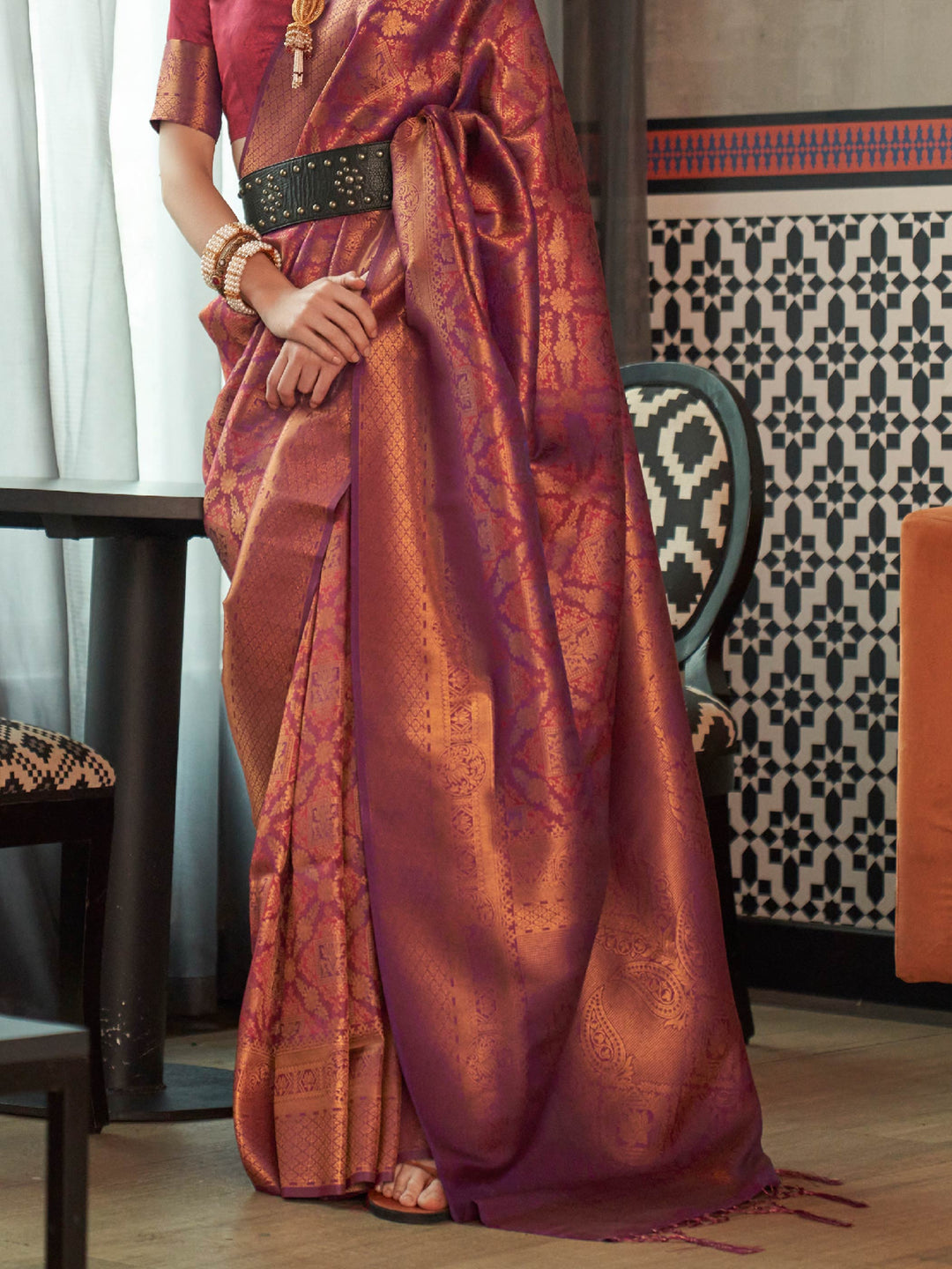 Glossy kanjivaram weave in Maroon–Copper with intricate pallu motifs and elegant fall. Classic Maroon–Copper bridal saree in silk with woven zari pallu and tassel finish.