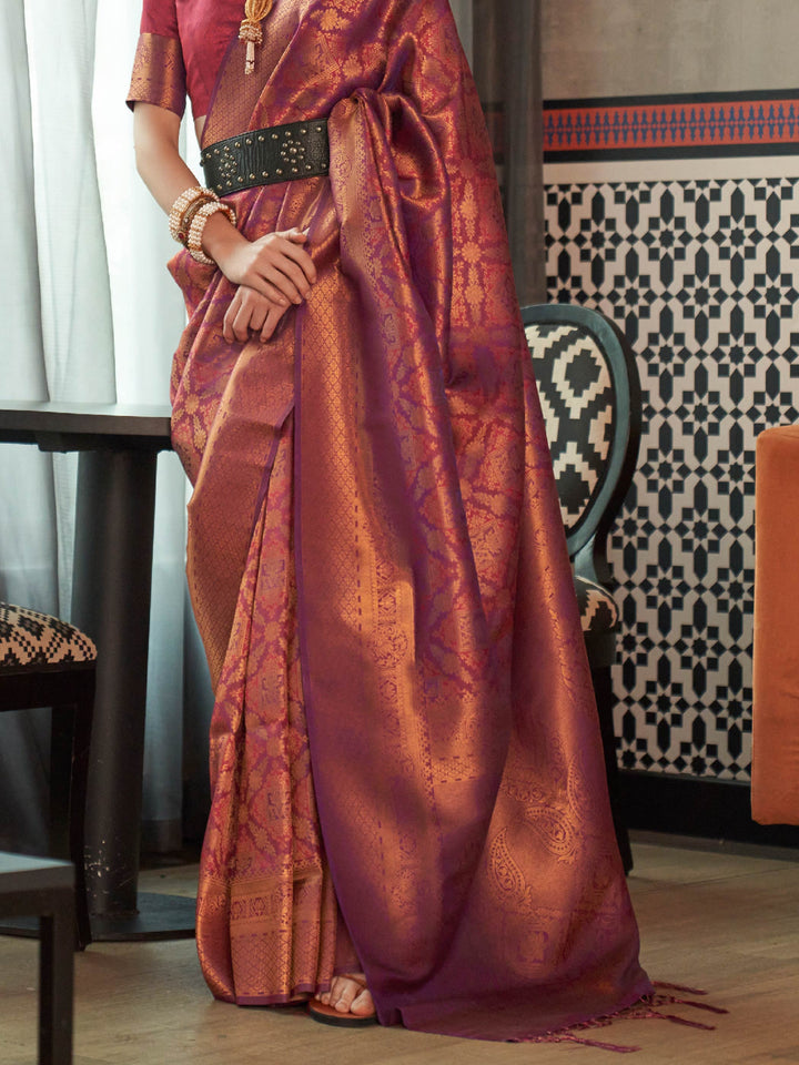 Glossy kanjivaram weave in Maroon–Copper with intricate pallu motifs and elegant fall. Classic Maroon–Copper bridal saree in silk with woven zari pallu and tassel finish.