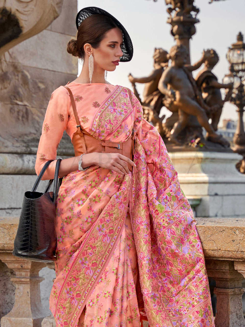 Blush Peach organza parsi silk saree with intricate multicolor thread floral embroidery and handloom craftsmanship, ideal for sangeet and styled perfectly for sister of the bride elegance and fashion-forward flair. This image captures the side angle view showcasing blouse styling and zari border detail, ideal for visualizing festive elegance, designer appeal, and modern styling inspiration. Perfect for online shoppers seeking detailed previews before purchase, enhancing saree visual merchandising and SEO-ri
