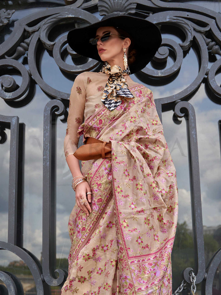 Champagne Beige organza parsi silk saree with intricate multicolor thread floral embroidery and handloom craftsmanship, ideal for wedding and styled perfectly for reception glam elegance and fashion-forward flair. This image captures the side angle view showcasing blouse styling and zari border detail, ideal for visualizing festive elegance, designer appeal, and modern styling inspiration. Perfect for online shoppers seeking detailed previews before purchase, enhancing saree visual merchandising and SEO-ric