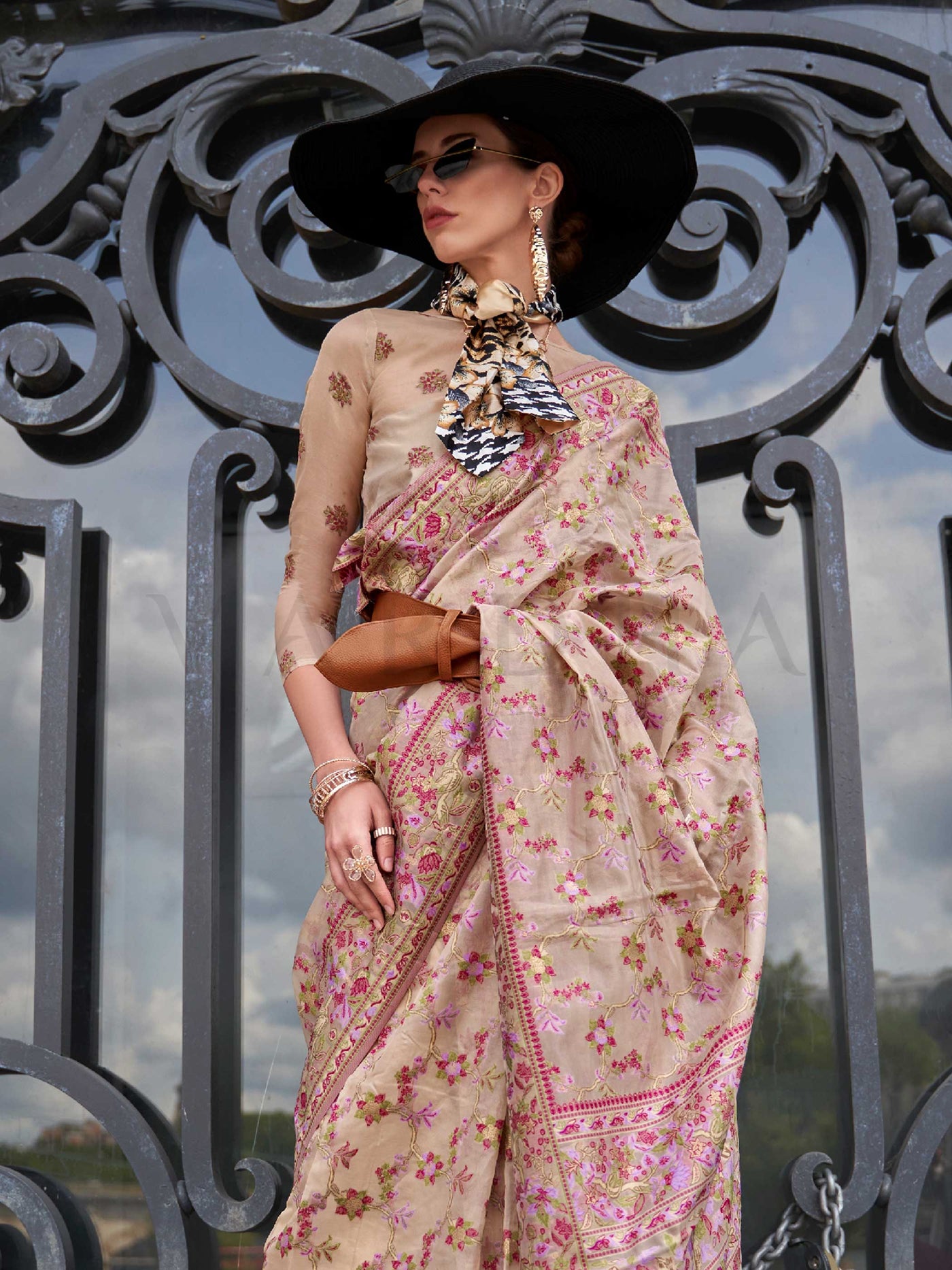 Champagne Beige organza parsi silk saree with intricate multicolor thread floral embroidery and handloom craftsmanship, ideal for wedding and styled perfectly for reception glam elegance and fashion-forward flair. This image captures the side angle view showcasing blouse styling and zari border detail, ideal for visualizing festive elegance, designer appeal, and modern styling inspiration. Perfect for online shoppers seeking detailed previews before purchase, enhancing saree visual merchandising and SEO-ric
