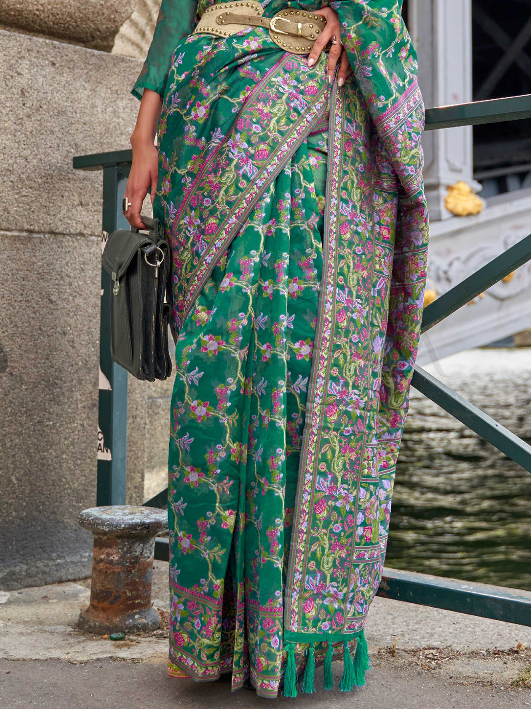 Emerald Green organza parsi silk saree with intricate multicolor thread floral embroidery and handloom craftsmanship, ideal for sangeet and styled perfectly for evening performance elegance and fashion-forward flair. This image captures the back drape focus revealing pallu finesse and motif richness, ideal for visualizing festive elegance, designer appeal, and modern styling inspiration. Perfect for online shoppers seeking detailed previews before purchase, enhancing saree visual merchandising and SEO-rich 