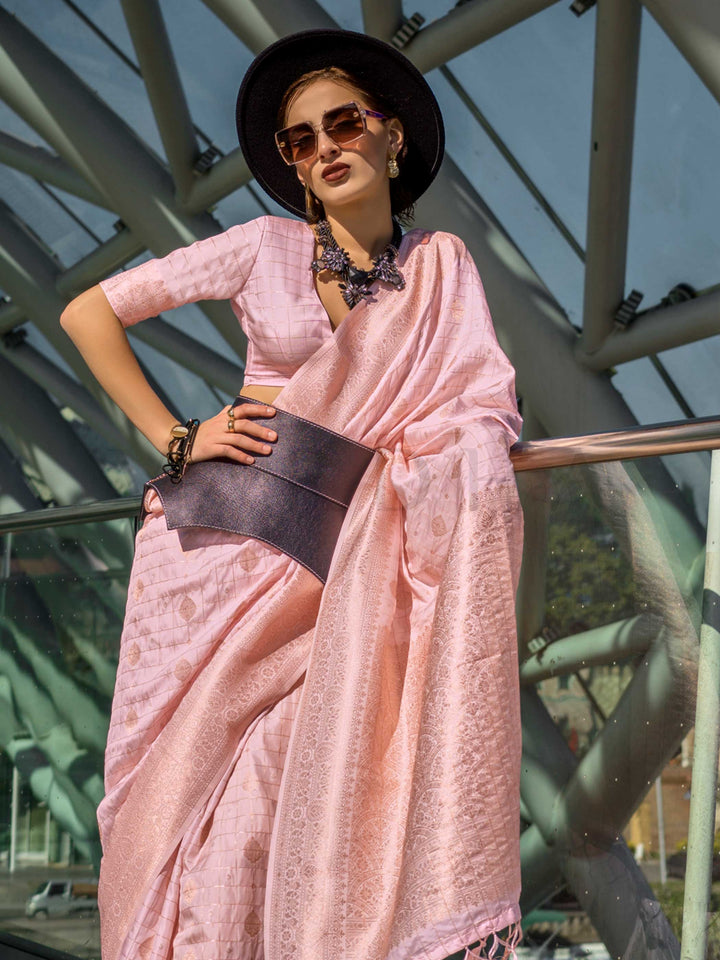 Blush Nude Katan silk saree with Ivory zari detailing, featuring checks handloom weaving, designer blouse and tasselled pallu — a perfect fit for party-wear and anniversary glam. Styled with modern belts, hats, and accessories to blend heritage and couture elegance. This image captures the side angle view showcasing blouse styling and zari border detail, ideal for visualizing festive elegance, designer appeal, and modern styling inspiration. Perfect for online shoppers seeking detailed previews before purch