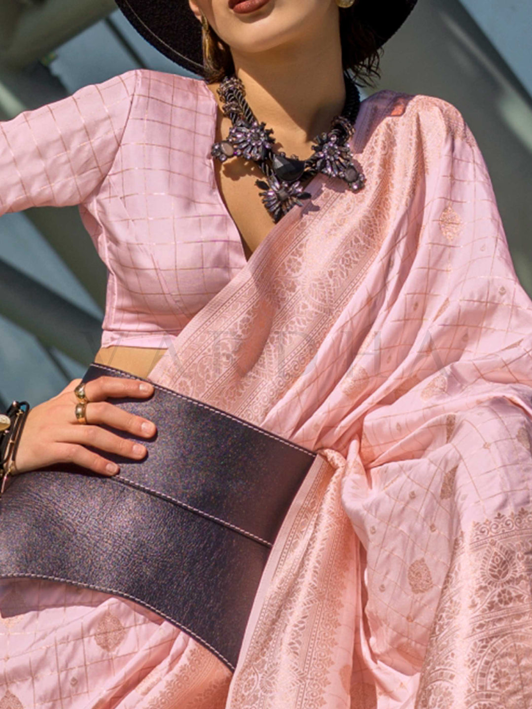 Blush Nude Katan silk saree with Ivory zari detailing, featuring checks handloom weaving, designer blouse and tasselled pallu — a perfect fit for party-wear and anniversary glam. Styled with modern belts, hats, and accessories to blend heritage and couture elegance. This image captures the zoomed texture view illustrating fabric weave and print clarity, ideal for visualizing festive elegance, designer appeal, and modern styling inspiration. Perfect for online shoppers seeking detailed previews before purcha