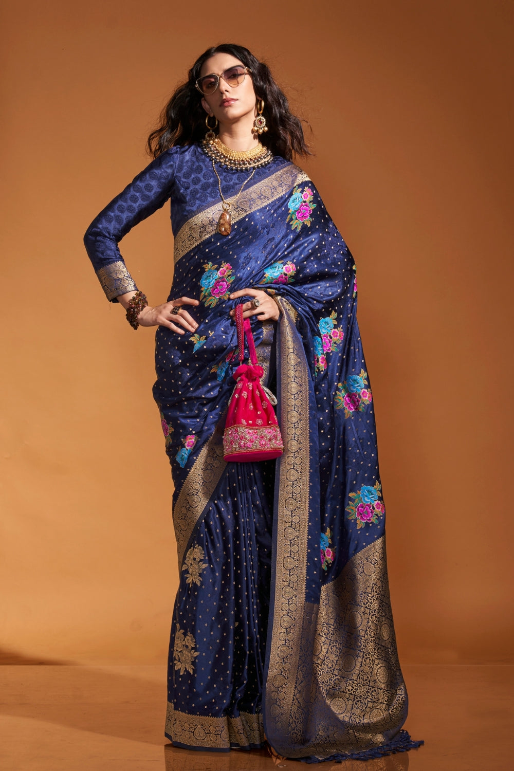 Navy Blue pure satin silk saree with multicolour floral handloom weaving and rich zari border. Styled for wedding and perfect for reception night, blending regal silk elegance with festive florals. This image captures the zoomed texture view illustrating fabric weave and print clarity, ideal for visualizing festive elegance, designer appeal, and modern styling inspiration. Perfect for online shoppers seeking detailed previews before purchase, enhancing saree visual merchandising and SEO-rich product display