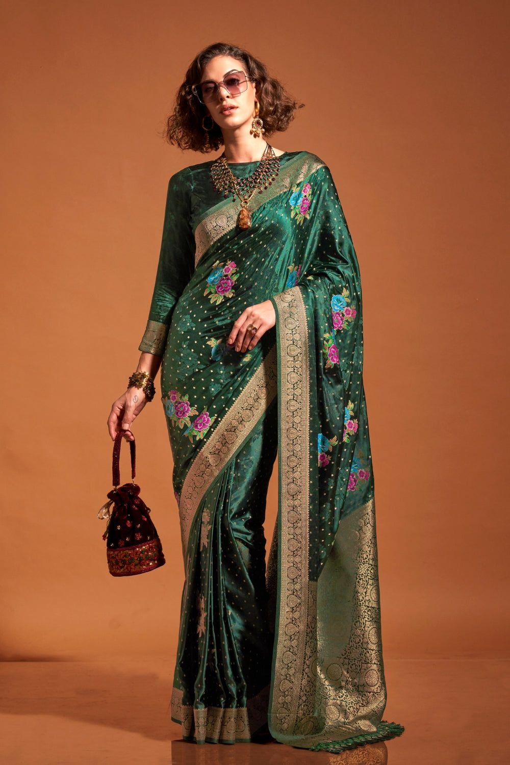 Bottle Green pure satin silk saree with multicolour floral handloom weaving and rich zari border. Styled for sangeet and perfect for evening bride entry, blending regal silk elegance with festive florals. This image captures the zoomed texture view illustrating fabric weave and print clarity, ideal for visualizing festive elegance, designer appeal, and modern styling inspiration. Perfect for online shoppers seeking detailed previews before purchase, enhancing saree visual merchandising and SEO-rich product 